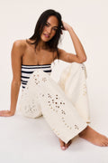 Ivory eyelet floral cutout wide-leg jeans with decorative perforated panels
