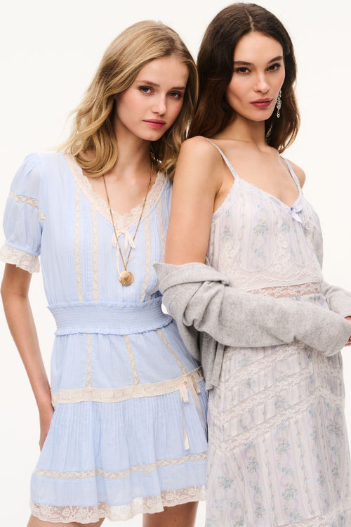 Light blue cotton mini dress with lace trim, puff sleeves, tiered ruffles and bow ties