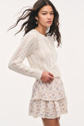 Cream textured ribbon cardigan with button front, bow ties, long sleeves, side view
