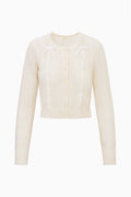 Cream alpaca-blend ribbon cardigan with button front and bow ties, long sleeves