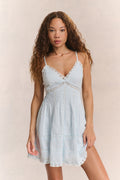 Light blue cotton mini dress on model, V-neck, spaghetti straps, tiered skirt