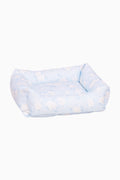 Light blue printed dog bed with padded bolsters and open top