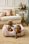 Printed dog bed with pink floral cover and two small dogs sitting in it