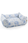 Printed dog bed with light blue pattern fabric and low bolstered cushion sides