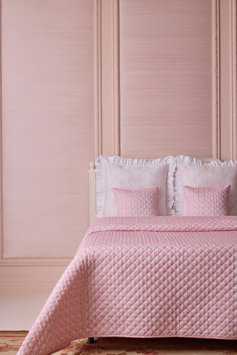 Pink diamond-quilted quilt with matching shams and ruffled edge