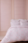 Light pink embroidered duvet cover with matching shams and gathered ruffle edges