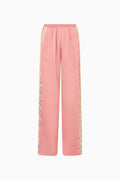 Pink satin lounge pants with elastic waist and lace side panels