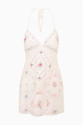 White embroidered patchwork mini dress with spaghetti straps and crisscross tie back