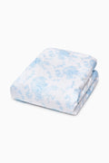 Folded light blue printed duvet cover with delicate floral pattern