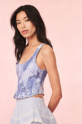 Floral denim bustier top in blue with spaghetti straps and center-front zipper seam