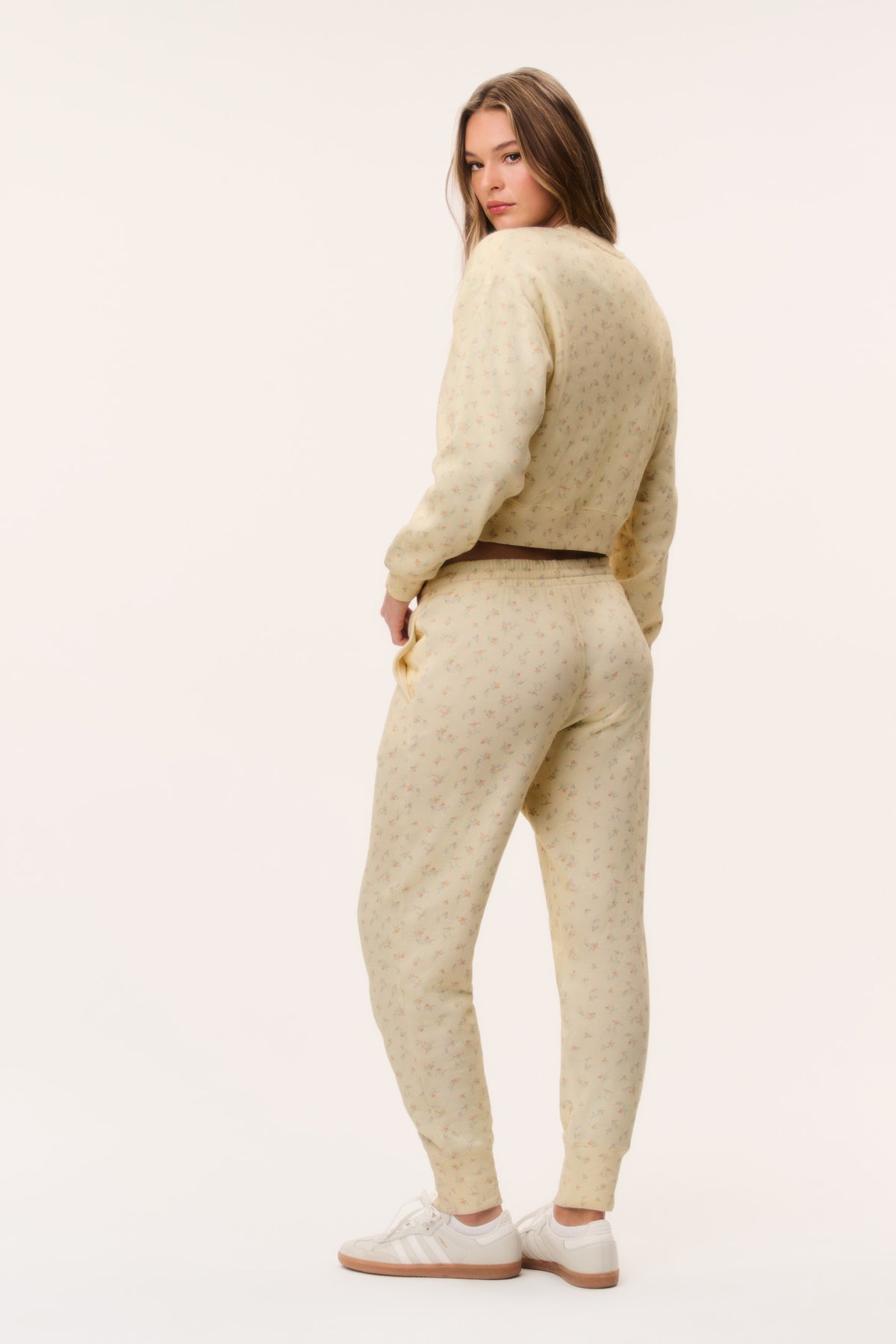 Cream ditsy floral sweatpants with elastic ankle cuffs and tapered fit