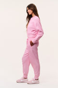 Pink ditsy floral sweatpants from side view, elastic waist with drawstring ties