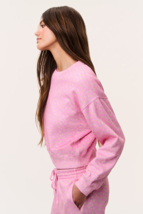 Pink cropped pullover with tiny ditsy floral print, cuffed sleeves, relaxed fit