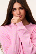 Pink cropped pullover close-up with tiny ditsy floral print, crew neckline