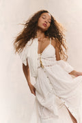 White cotton midi dress with spaghetti straps, button front, and layered ruffle hem