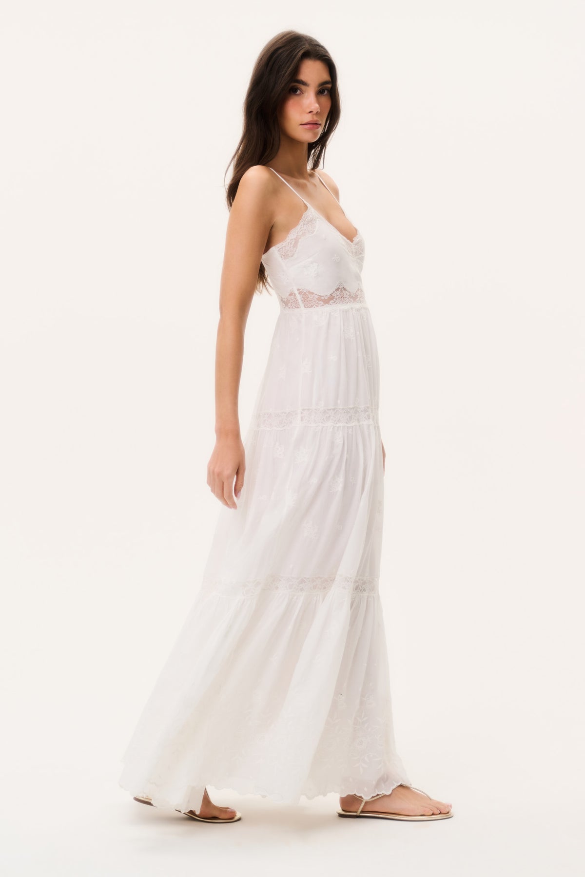 Optic white lace maxi dress with spaghetti straps, layered ruffles, side view