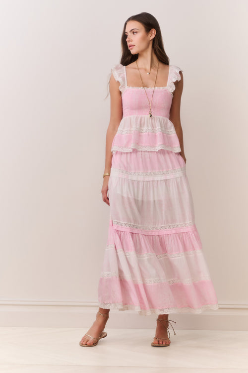 Tiered pink maxi skirt with ruffled tiers and mixed print design