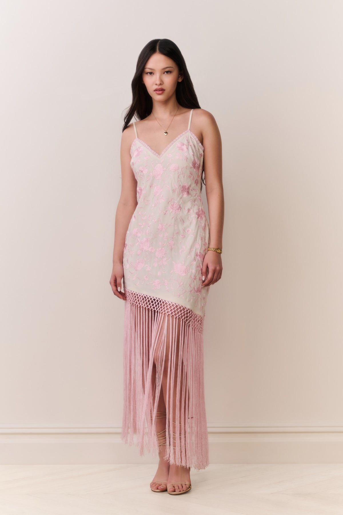 Pink floral maxi dress with V-neck straps and layered fringe at the hem.