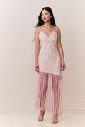 Pink floral maxi slip dress with spaghetti straps and long fringe along hem.