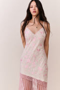 Pink floral maxi slip dress with thin straps and scalloped V neckline; fringe hem.
