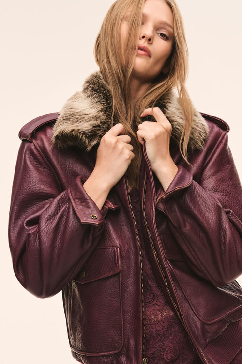 Faded merlot leather bomber jacket with faux fur collar and flap front pockets