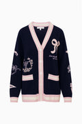 Navy wool varsity cardigan flat lay with button-front, pink V-neck, and patches
