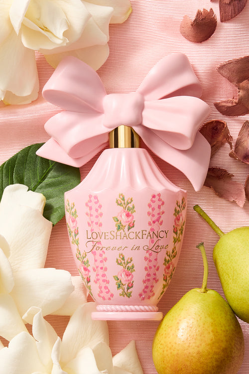 Pink satin bow gift pouch with LoveShackFancy pink floral candle jar