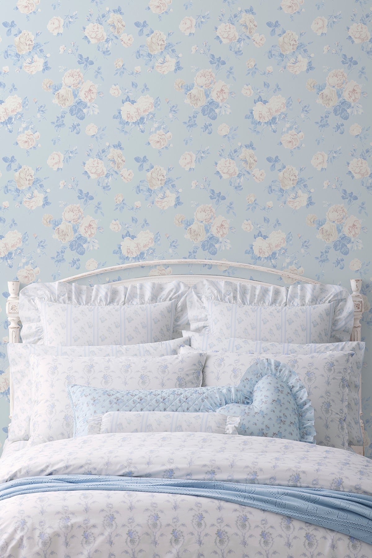 Whisper blue peel-and-stick wallpaper on wall with pale blue floral motif