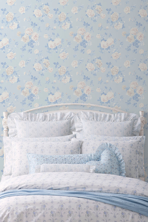 Whisper blue peel-and-stick wallpaper on wall with pale blue floral motif