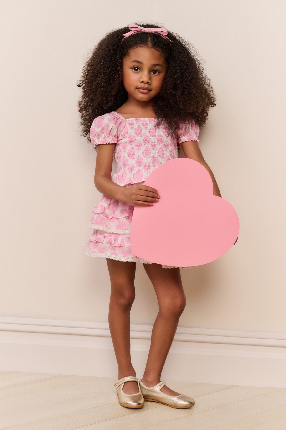 Girls pink heart-print top with puff sleeves and layered ruffle peplum hem
