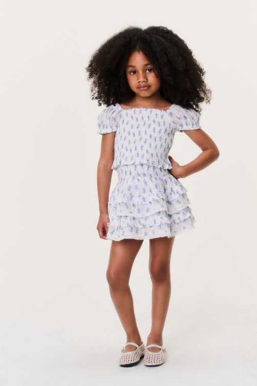 Girls indigo cloud short tiered ruffle skirt on model, light blue pattern