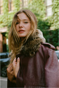 Faded merlot leather bomber jacket with faux fur collar, front zip close-up