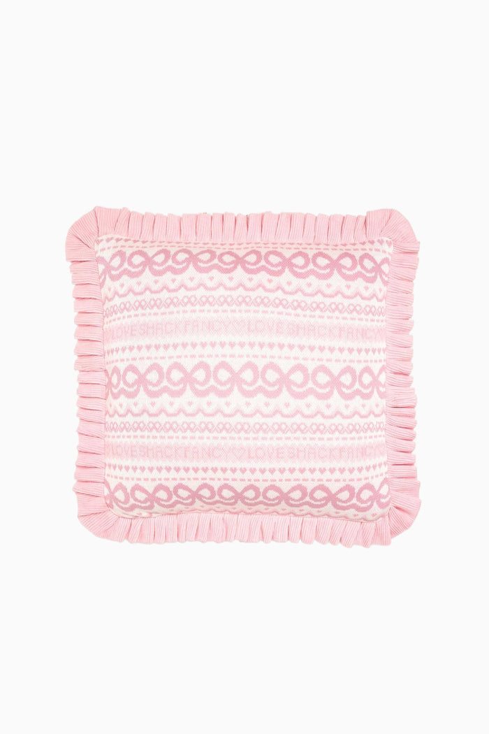 Pink and white fair isle jacquard knit throw pillow with repeating motif, ruffled border