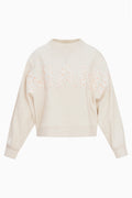 Cream mockneck crew sweatshirt with pink dotted graphic across the chest