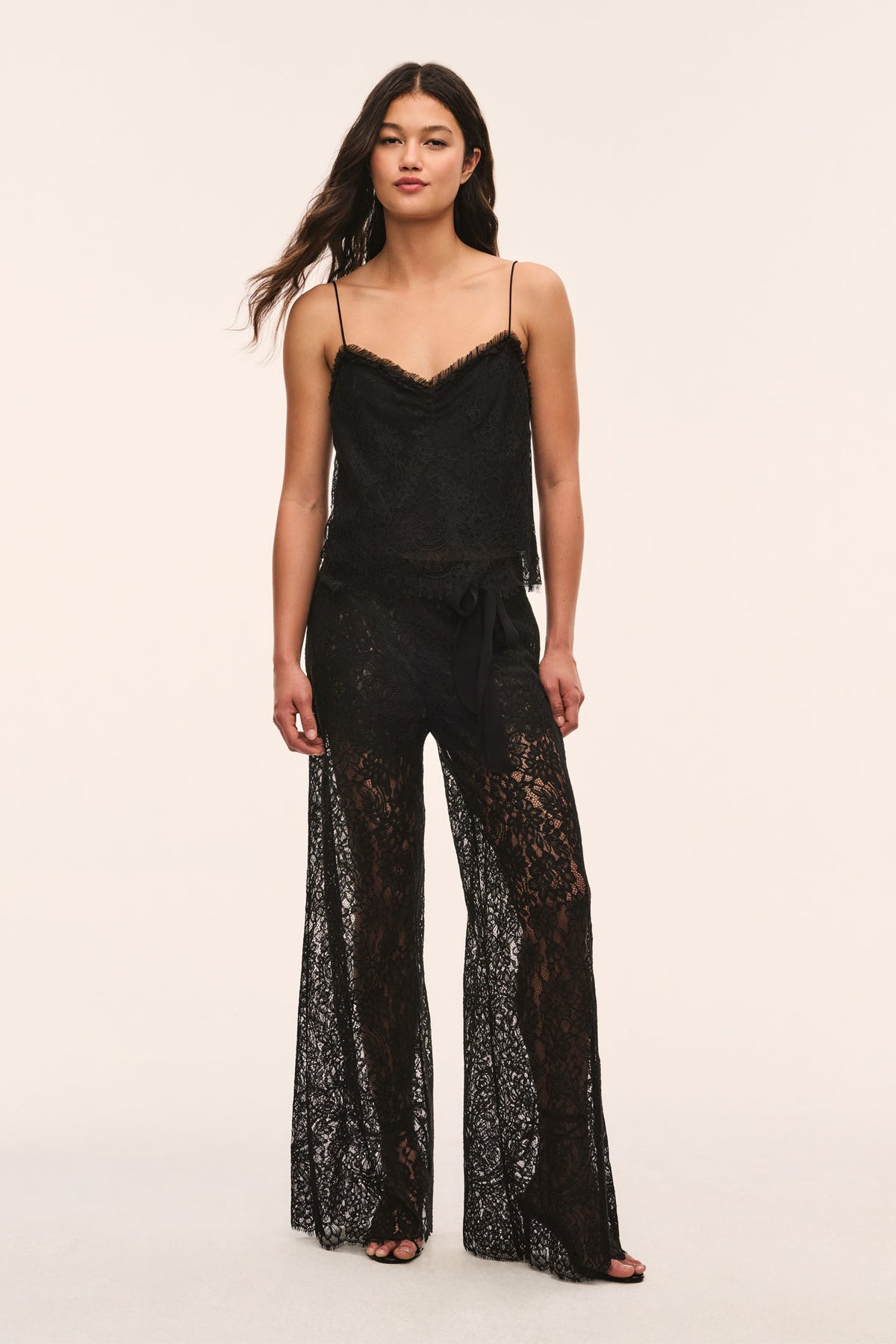 Black sheer lace wide-leg pants with scalloped trim and fitted tie-free waist.