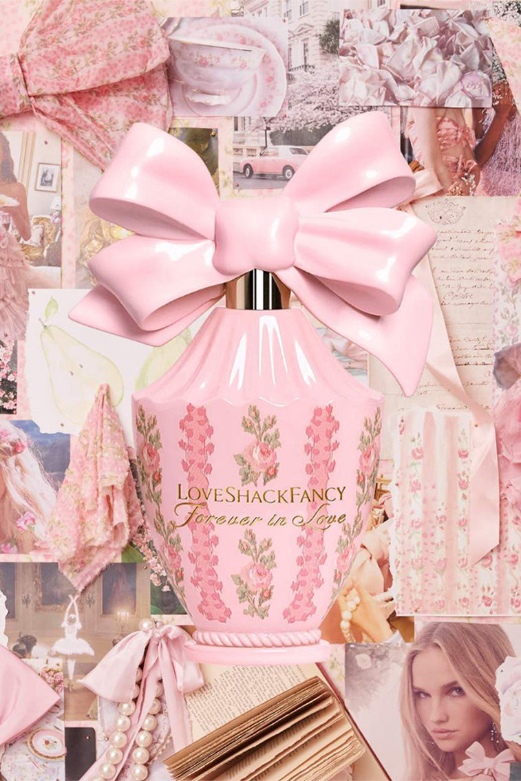 Pink perfume spray bottle with oversized satin bow and floral print, front view