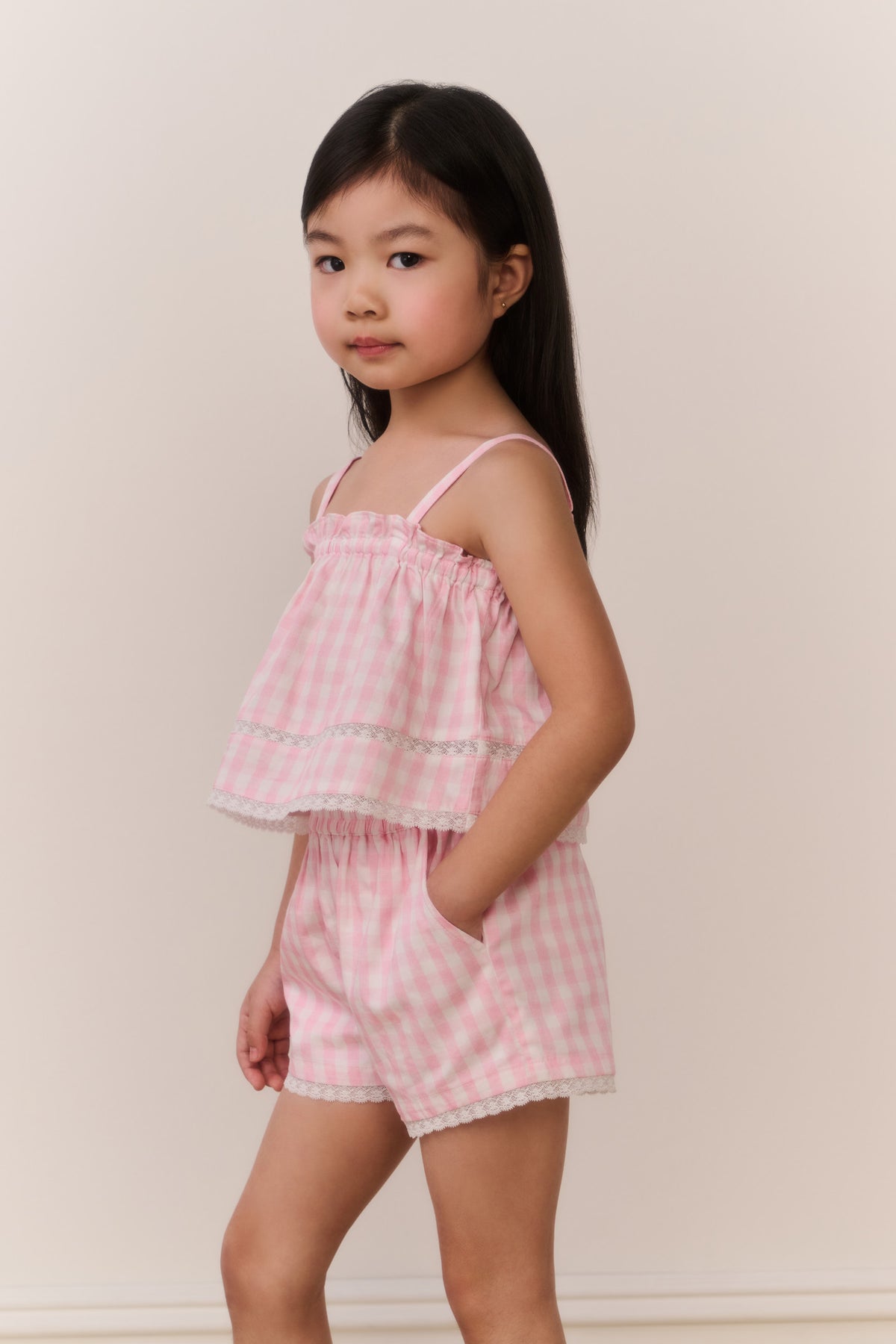 Pink gingham girls' shorts with elastic waistband and layered ruffle hem