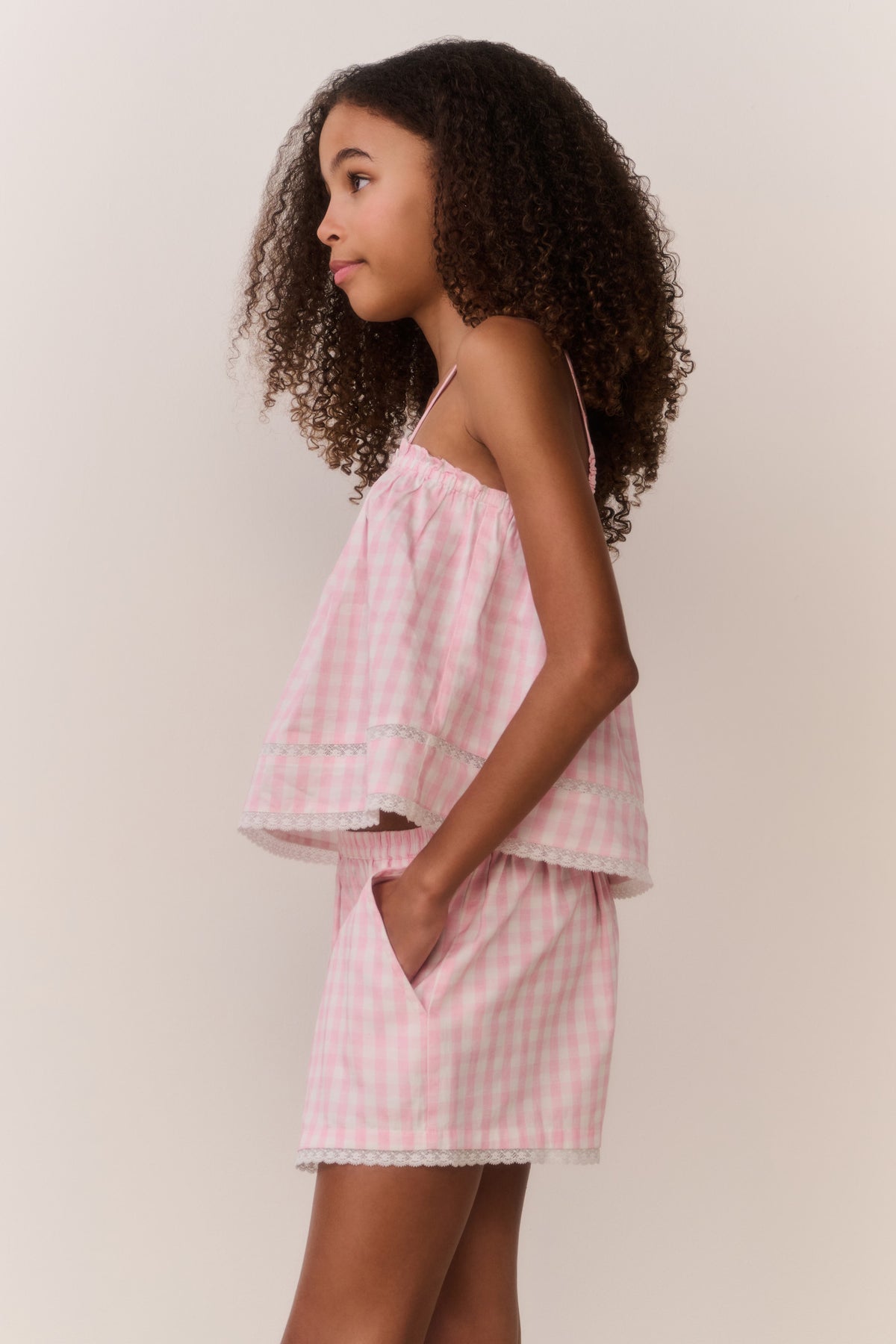 Pink gingham cami top with thin straps and tiered ruffle hem
