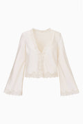 Cream lace-trimmed crepe top with long bell sleeves and V-neck