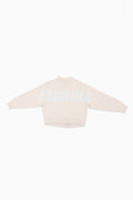 Cream mockneck crew sweatshirt with light blue dotted lettering across the front