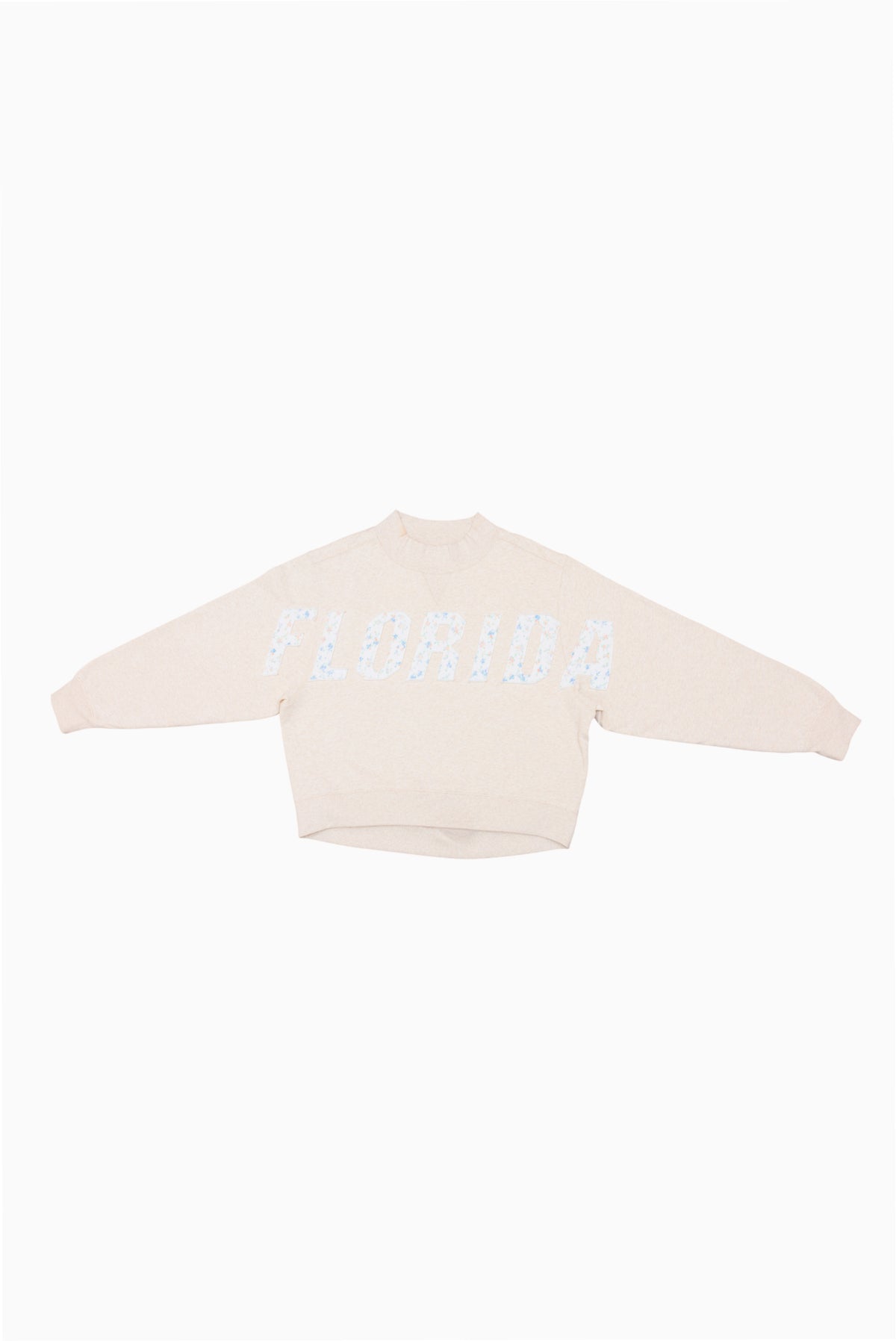 Cream mockneck crew sweatshirt with light blue dotted lettering across the front