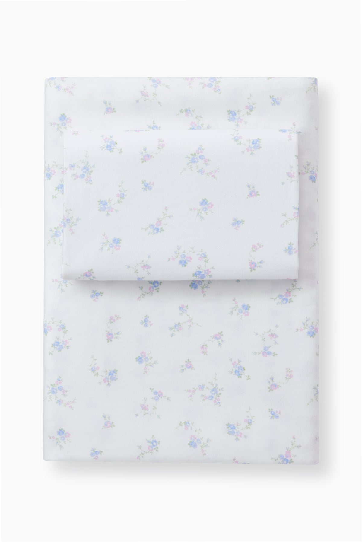Light blue bow printed sheet set with pillowcases, folded stack on a base