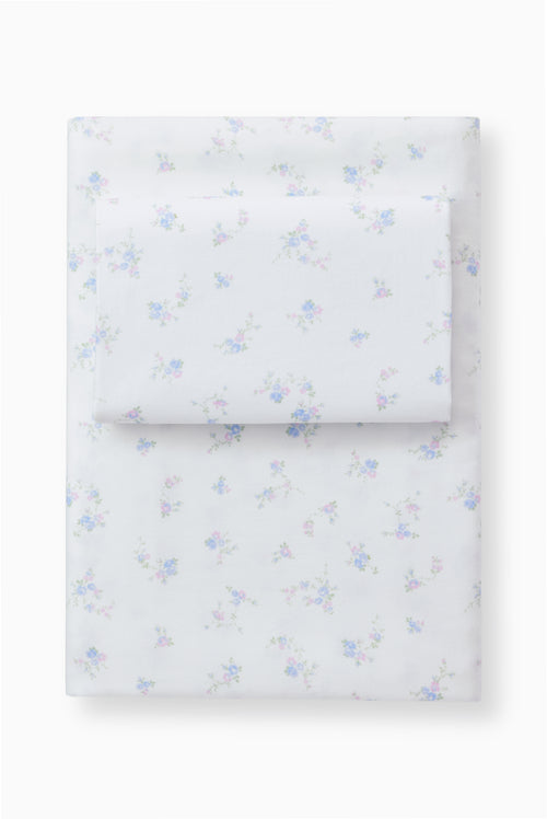 Light blue bow printed sheet set with pillowcases, folded stack on a base