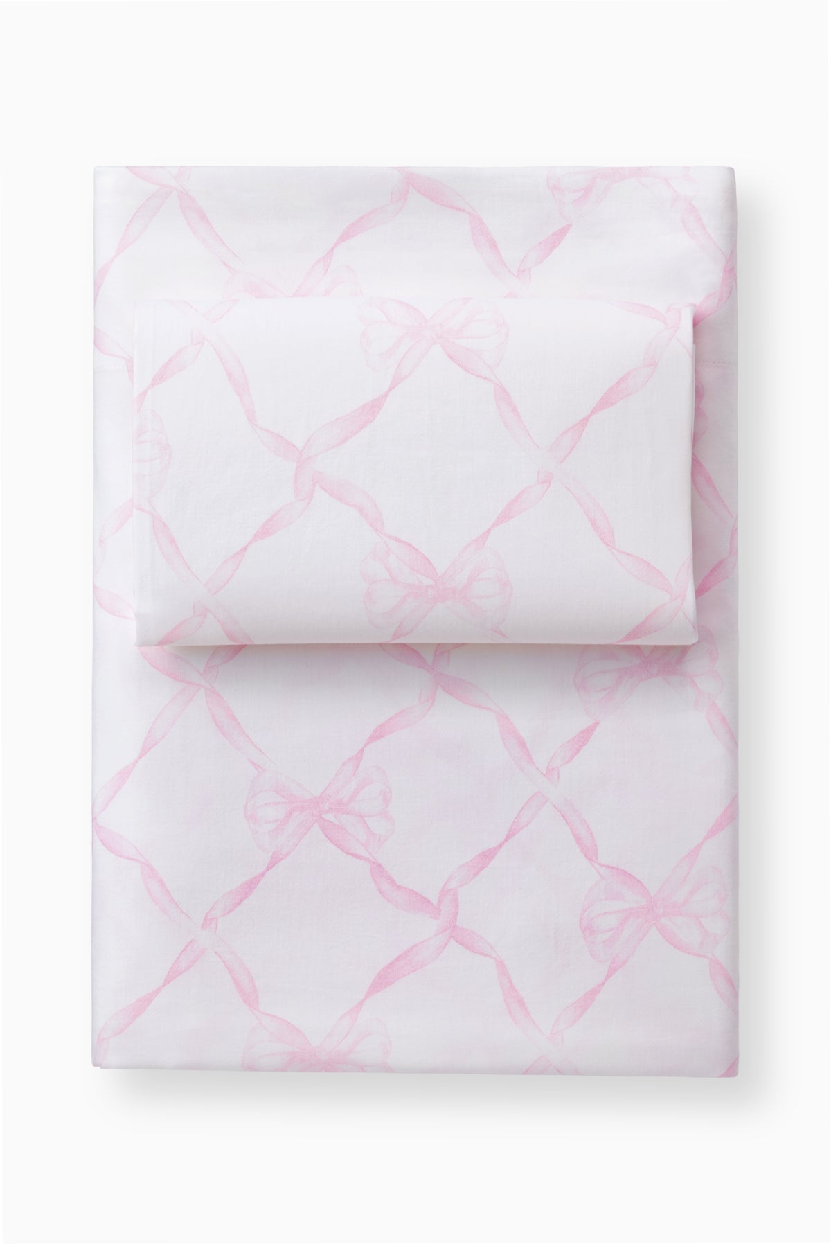 Light pink bow printed sheet set with pillowcases, folded stack on a base