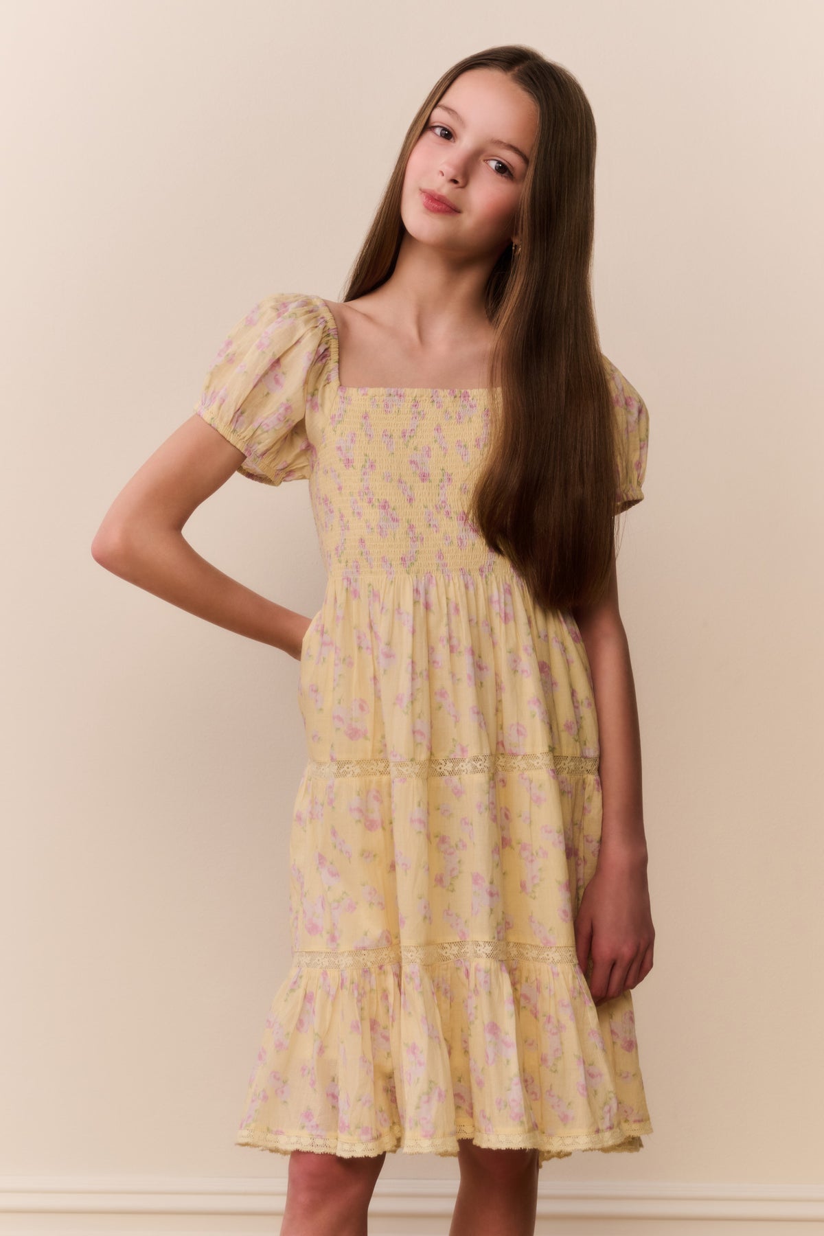 Yellow floral tiered mini dress with square neckline and puff sleeves, ruffled hem