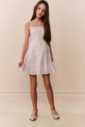 White cotton lace-trimmed cami dress with spaghetti straps and ruffled tiered skirt