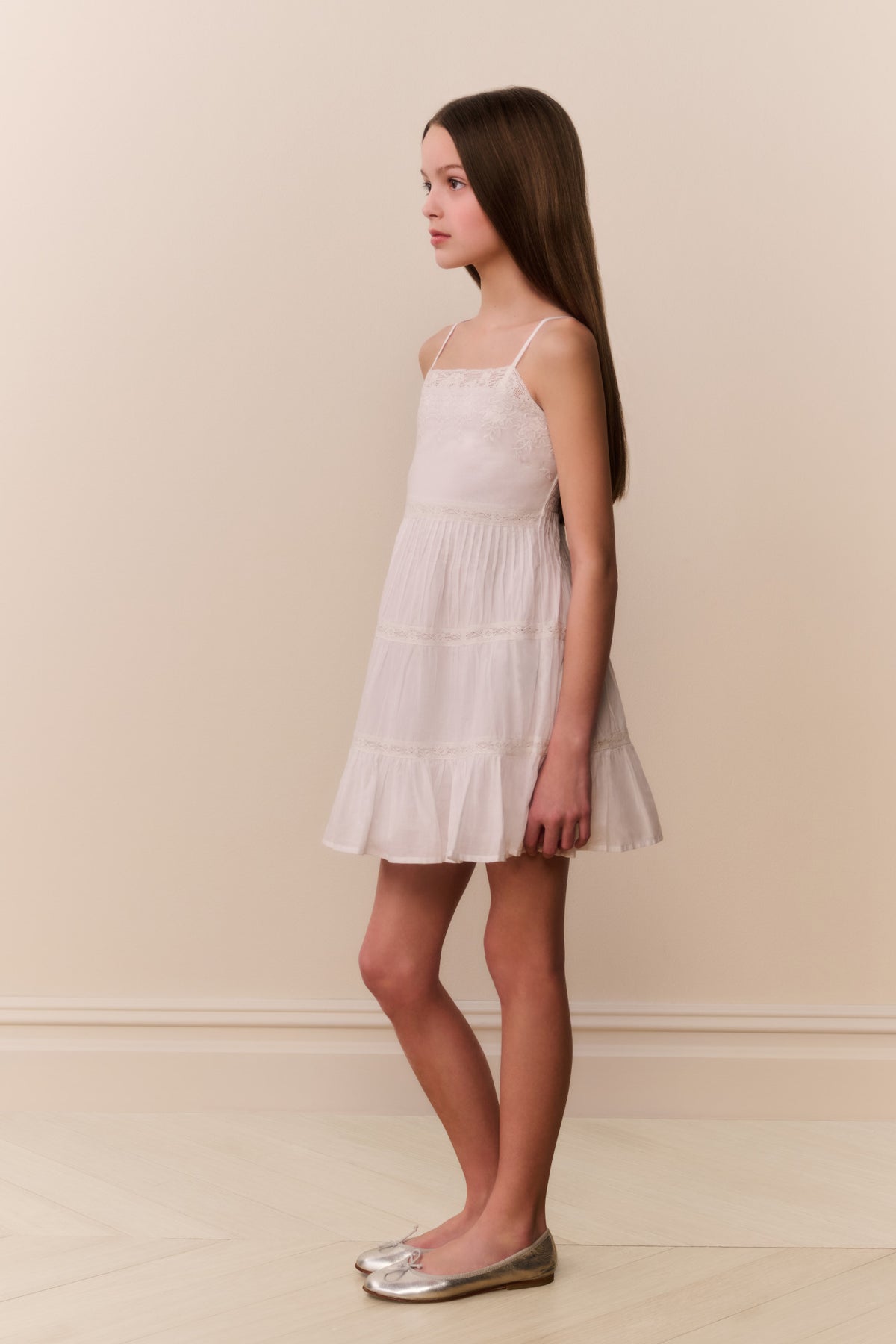 White cotton lace-trimmed cami dress with spaghetti straps and layered tiered skirt