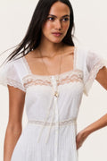 Ivory cotton lace bodice with square neckline, scalloped lace trim, and gold button