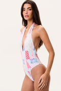 Halter one-piece swimsuit with plunging V-neck, patchwork print in white, blue, and pink.