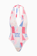 Halter one-piece swimsuit with V-neck front, patchwork print in white, blue, and pink.